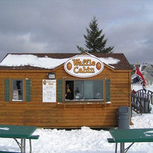 <p><b>Location:</b> On the slopes of Vermont, New Hampshire, New York, and Massachusetts</p><p><b>What You'll Find:</b> OK, so it's not actually a drive-thru; the <a href="http://wafflecabin.com/locations/vermont/okemo" target="_blank">Waffle Cabin</a> is a ski-thru. For ski bums on the go who don't have time between mogul runs to sit down and unbuckle, the small, mountainside log cabin serves up freshly made waffles dusted with extra sweet sugar.</p>