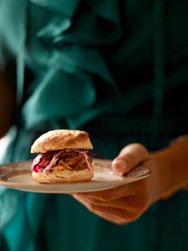 <p>Savory pulled pork is sandwiched between homemade mini biscuits in this delicious party dish. <br /><br /> <strong>Recipe:</strong> <a href="http://www.countryliving.com/recipefinder/pulled-pork-biscuits-recipe target=">Pulled Pork & Biscuits</a></p>