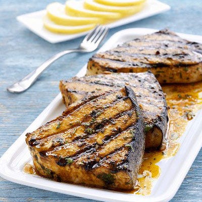 <p>The challenges when grilling fish are twofold. Your first intent is to sear the fish  so that you achieve a crispy outside while ensuring that the fish will be cooked all the way through. The end goal? A nicely charred exterior that envelops the smooth and luscious texture of the fish. Fish such as tuna, salmon, halibut, and swordfish, whose texture is more like beef or pork, should be grilled directly on the grate. (More delicate fish, such as tilapia, sole, and flounder, sometimes fare better when grilled in a foil packet or grill basket.)</p>
<p><b>Recipe Idea: <a href="http://gogonow.org/recipefinder/grilled-tuna-lemon-anchovy-butter-recipe-7659%22 
target="_blank">Grilled Tuna with Lemon Anchovy Butter</a></b></p>
