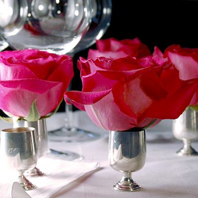 Long-stem roses have had their due so what about no-stem roses? Create dramatic place settings with shot glasses, egg cups, and other small containers. By using these undersized glasses, your roses will look larger than life. Don't trim stems completely; by leaving a few inches, you'll keep the flower stable in the glass as well as provide a source of hydration.