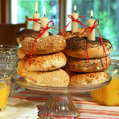 Have an early-morning birthday celebration with bagels or plain doughnuts instead of sugary cupcakes. Stack bagels atop a cake plate and place taper candles within each stack. Alternating pumpernickel and egg bagels or sesame and poppy can create colorful patterns. To ensure that the candles stay upright and don't lean on the bagels or doughnuts, drip some melted wax on the plate to use as an anchor. Festive ribbons add the final touch; just be sure to blow out the flames before they get too close!