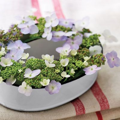 Ring around the posy: An oval enamelware mold provides the perfect "nest" for small flowers. Anchor stems in florist's foam or nestle inside glass baby-food jars.