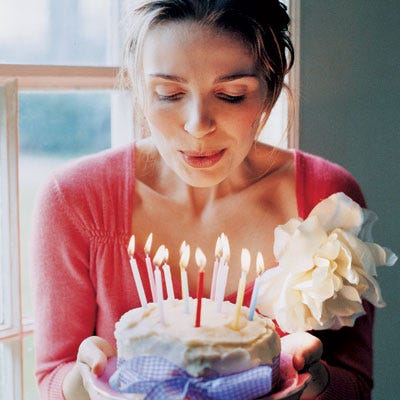 A store-bought birthday cake is dressed up for the occasion in brightly colored candles and a charming gingham bow. Guests are kept hydrated and happy — before and during the party — with a nearby beverage and dessert station. For country-fresh tablecloths, use sheets, cotton yardage, or oilcloth. Plop cushions on hay bales or benches, and suspend paper or fabric "flags" from lengths of twine.