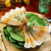 <p>The herb bouquet cinches the napkin in the center,
allowing the edges to fan across the plate.</p><br />