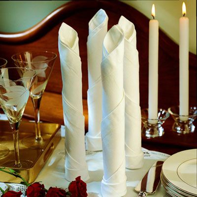 <p>To imitate the shape of a taper candle, roll your napkin and place it upright at the table or buffet.</p><br />