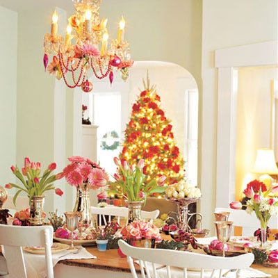 <p>A simple white-on-white interior provides a perfect backdrop for a glimmering tablescape. Tall flower arrangements in silver containers alternate with smaller bouquets to create visual interest.</p>