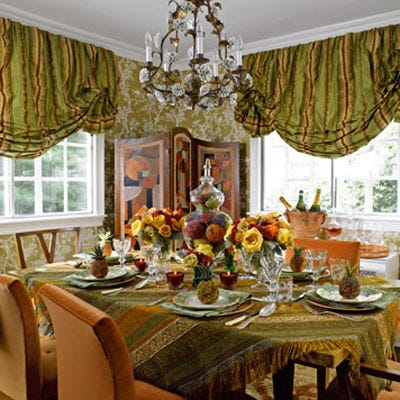 <p>This room is a jewel box of color. Beaded fruit, bouquets of flowers, deep red votives, and holiday-hued plates come together in a celebration of seasonal tones.</p>

