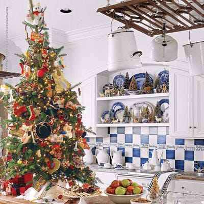 <p>This small tree, along with mini trees in teacups on shelves, makes a cheerful setting for a casual holiday breakfast.</p>