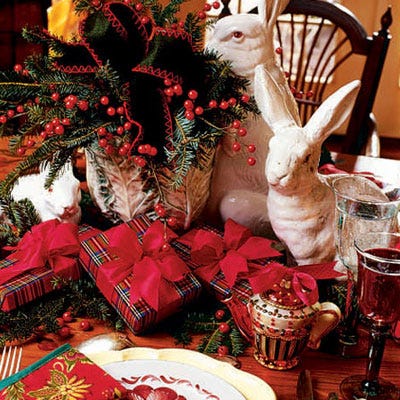 <p>Another tabletop centerpiece shelters faience rabbits in a spray of berries, bows, and greenery. Simple accents, like a Kurt Adler teapot and an assortment of plaid-wrapped packages, highlight the service of hand-painted French faience platters and dishes.</p>