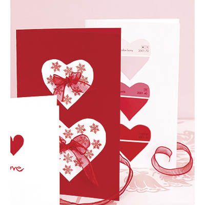 <p>Left: Start with a blank red card. Cut out two white paper hearts, then stamp them with a small rubber stamp (we used a snowflake design). Paste the hearts to the card. Finally, affix a small bow to the center of each heart with craft glue.</p><br />
<p>Right: This graphic love note is a white card decorated with three hearts cut out of a red-toned paint strip. For an extra-cute touch, look for chips with names like "blush" or "coral kiss."</p>