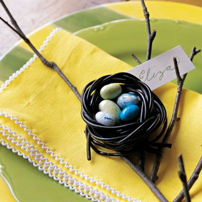 A sweet twist on place cards! To make, twist two or three black-licorice laces, creating a cup. Soften in microwave for 20 seconds. Reshape. Let cool, then nestle candy eggs inside.