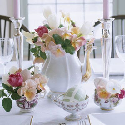 Easter brunch will be both elegant and informal with a centerpiece composed of sweetly mismatched tea sets. Pull out your own collection or check antiques stores and eBay for inexpensive vintage pieces in the same color palette (here, a lidless gold-trimmed teapot with patterned porcelain teacups). Fill with a relaxed arrangement of tulips and pansies in shades of cream and pink. Tuck decorative eggs amid the teacup blossoms, and give the real attention-getters, like this green plaid one, a solo display.