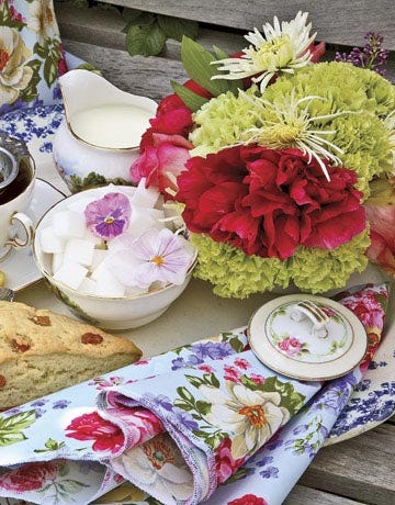 Set up a flower-filled spread for a daytime tea party. Offer a variety of teas and scones served in elegant china with floral-print paper napkins. Let each guest take a teacup as a favor.