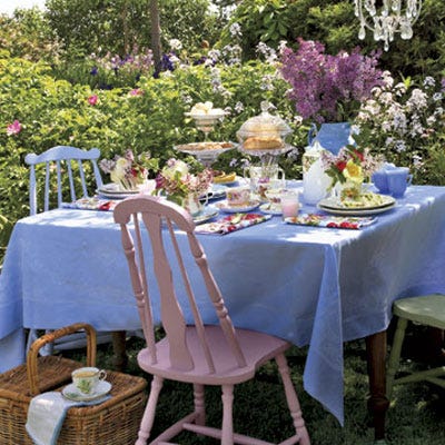Shades of pastel and an abundance of flowers are the foundation of a fanciful backyard tea party. A jug of fragrant lilac branches, floral-print napkins, silver teaspoons, and tiered serving pieces all add a touch of romantic grandeur to an easy afternoon.
