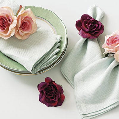 Brighten up your table for entertaining with these floral napkin rings. Buy faux roses in your favorite hues at a crafts store, then sew them, singly or in pairs, onto regular hair elastics with a few stitches.