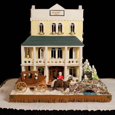 <p><b>Location:</b> The Grove Park Inn & Spa's 2009 Gingerbread Competition (Asheville, NC)</p>
<p>Rita and Monte Adams' scene tells the story of Santa getting ready to ride out of an old western town following dinner at the Jingle Café, gift shopping at the Rocky Mountain toy shop, and a night's rest at the Holly Tree Hotel. In the scene, Santa has saddled up a solid chocolate horse while elves have loaded his coach with Christmas toys. The couple used 15 pounds of flour, 22 1/2 pounds of fondant, 12 pounds of sugar, and dozens of other ingredients to make this gingerbread tableau.</p>