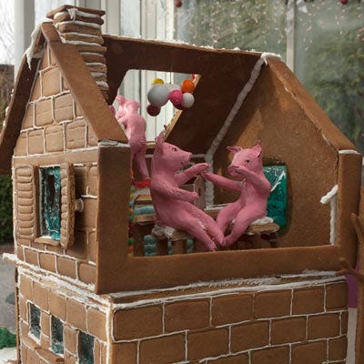 <p><b>Location:</b> The New York Botanical Garden's 2009 Gingerbread Adventures (Bronx, NY)</p>
<p>For her fairy-tale-themed confection, Cake Power's Kate Sullivan constructed an 18-inch-tall gingerbread house featuring three little pigs and a wolf all made of fondant (the original versions, made of modeling chocolate, melted in the Botanical Garden's greenhouse). The house itself, constructed of embossed gingerbread, featured such incredible tiny details as a jellybean-covered fireplace, string licorice rag rug, gumball lamp and vase, windows made of poured blue-tinted hard sugar, and a whimsical hanging portrait of a Star Wars clone trooper drawn in food marker.</p>