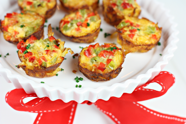 <p>Savory breakfasts can be festive too! Some red and green bell peppers adds Christmas flair and some nutrition to these mini quiches.</p> <p><strong>Get the recipe from <a href="http://pizzazzerie.com/recipes/party-recipe-mini-hash-brown-crust-quiche/" target="_blank">Pizzazzerie</a>.</strong></p>