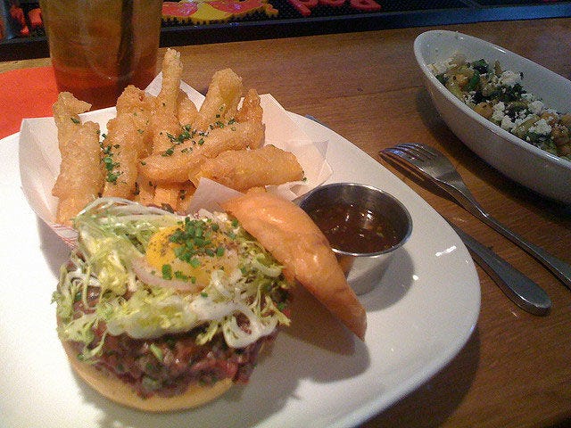 <p>This might not look like any burger you've had before, but don't let that shy you away from making it your order. The elegant richness of raw steak tartare is topped with a runny egg, frisee, and smoked mayo for a truly decadent version of the cookout classic. </p>
<p><em><strong>FLIP Burger Boutique:</strong> multiple locations; <a href="https://www.flipburgerboutique.com" target="_blank">flipburgerboutique.com</a></em></p>
