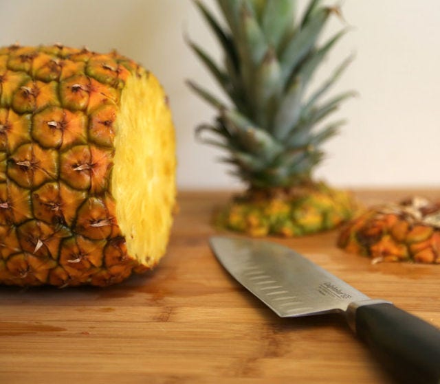 <p>Rotate the pineapple and cut off the bottom. This way, the pineapple can stand up on either end.</p>