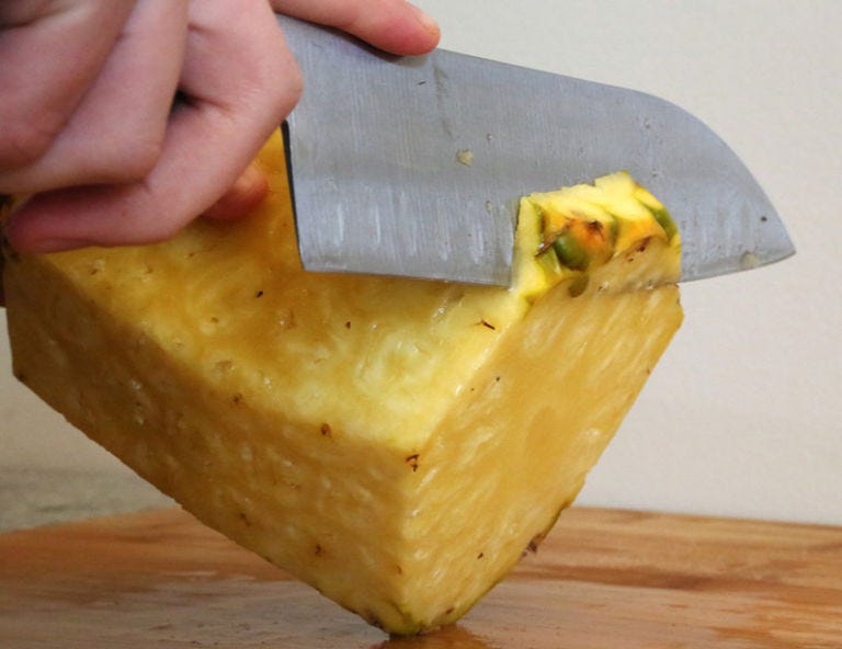 <p>Trim off any remaining skin. Also, use a melon baller to cut out the tough brown eyes in the flesh of the fruit. </p>
