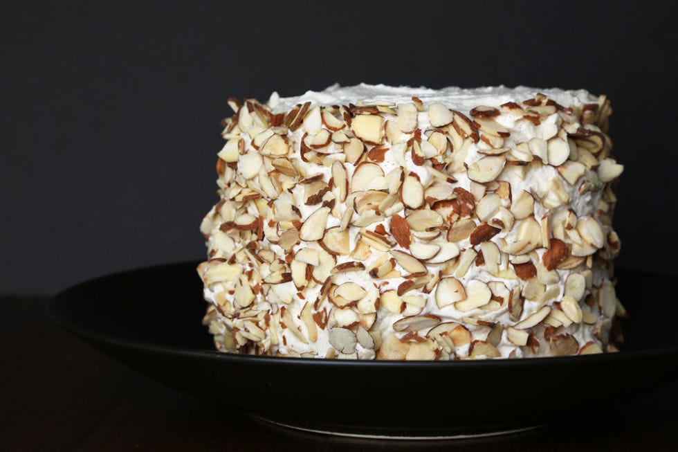 Take about two cups of toasted, slivered almonds (make sure they are completely cool) and toss them onto the sides of the cake. Occasionally, scoop the almonds that have collected on the bottom of the plate and pat them onto the sides until the entire circumference is covered.