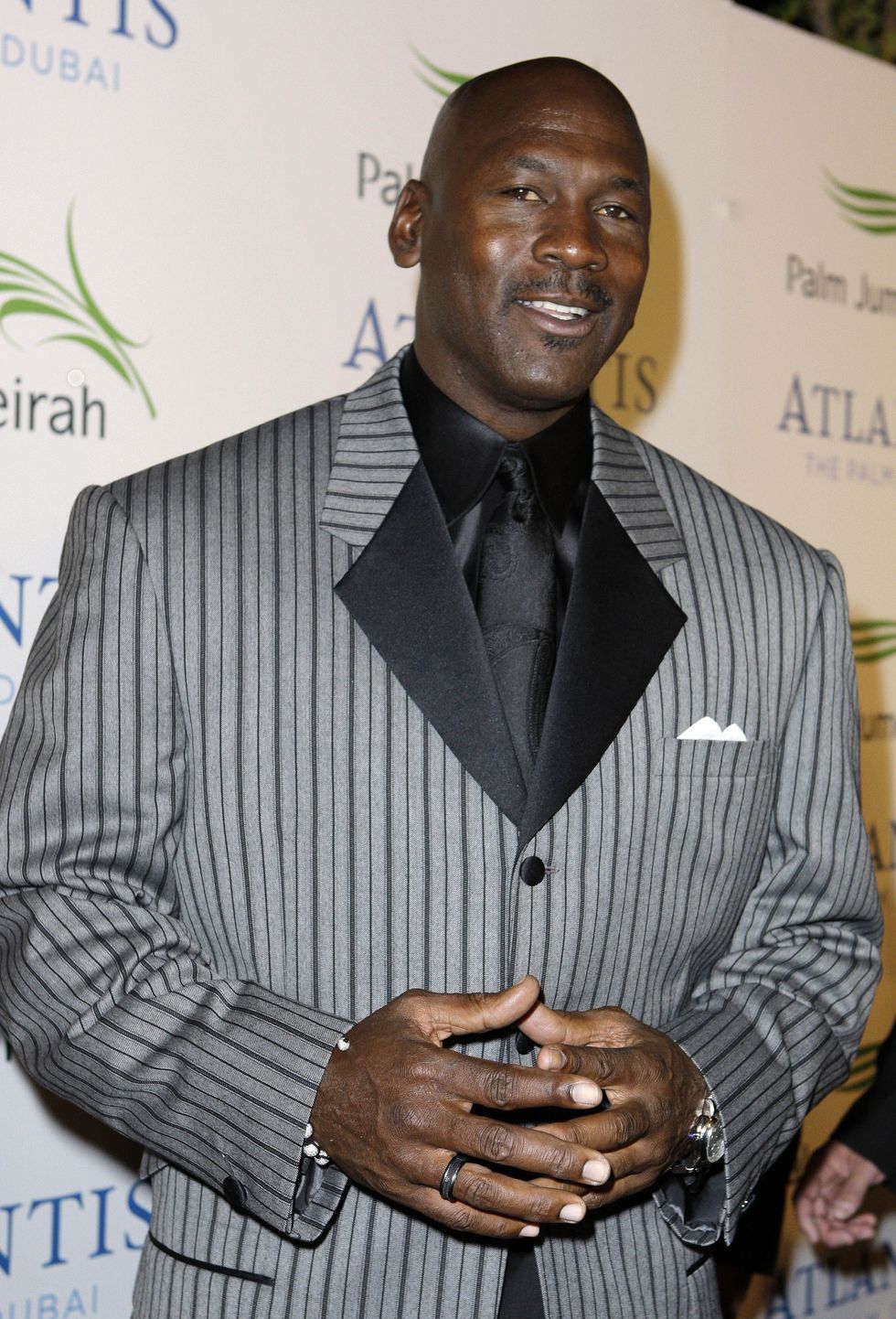 michael jordan in a grey suit on the red carpet