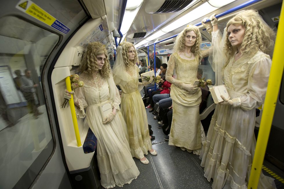Transport, Hairstyle, Standing, Dress, Public transport, Passenger, Bridal clothing, Gown, Blond, Metro, 