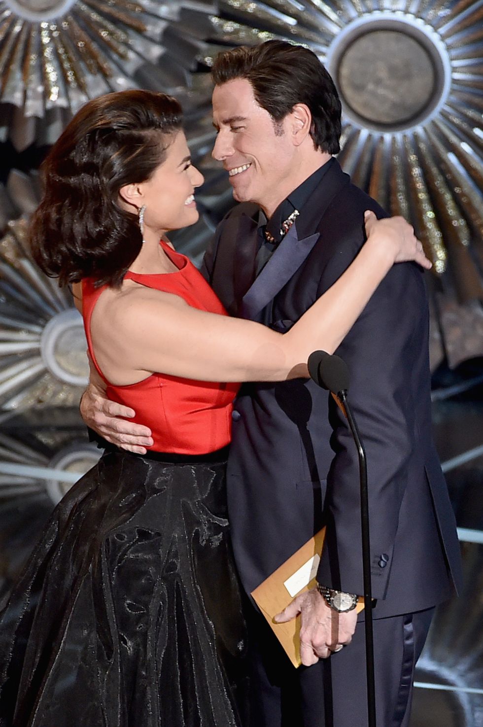 At the Oscars, Travolta and Menzel make light of last year's gaffe