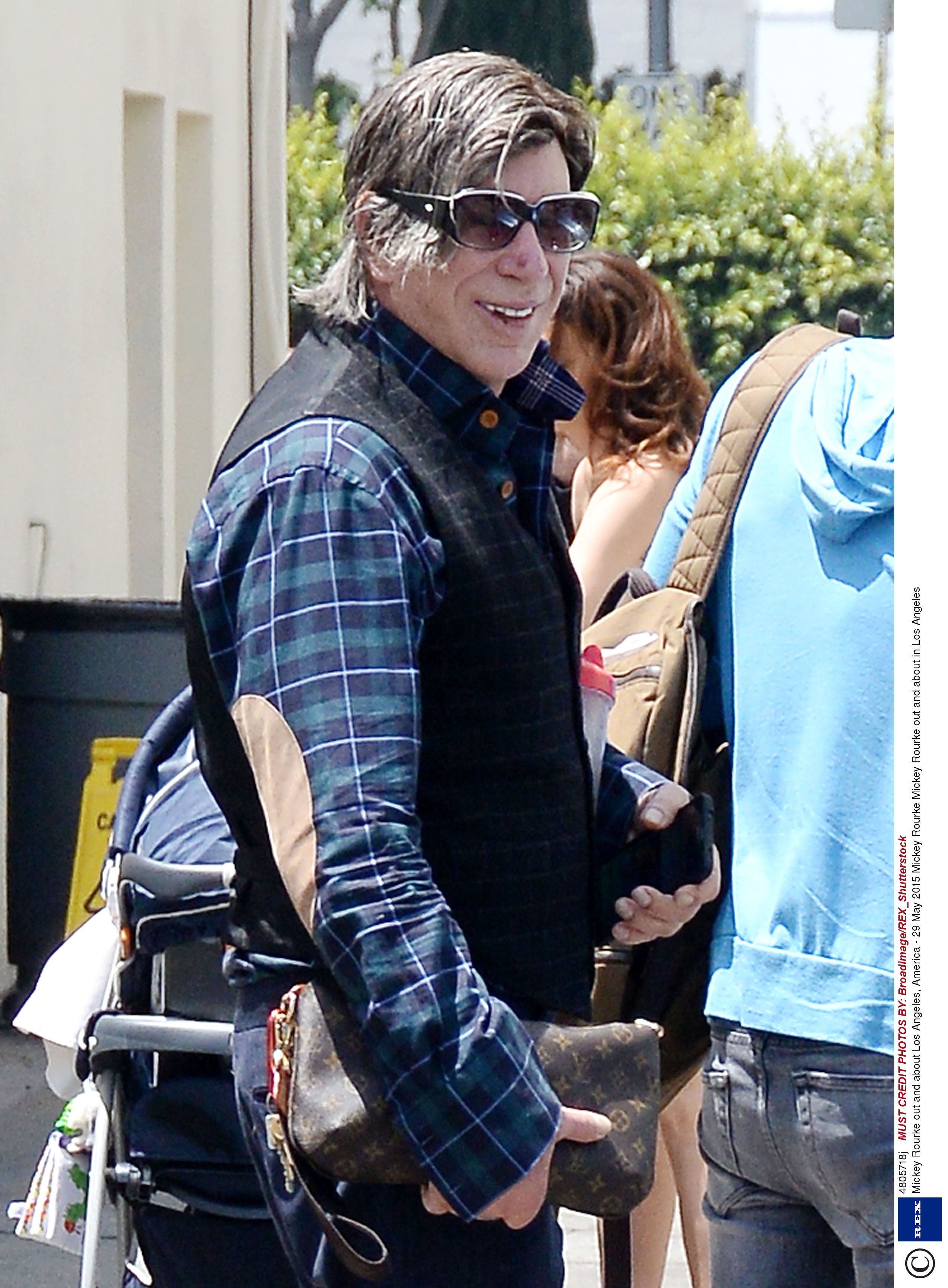 Mickey Rourke shows bizarre style choices with shades worn OVER