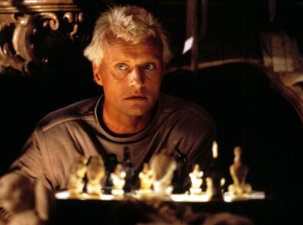 I noticed that in the teaser the kids were playing chess with some strange  chess pieces that originally appeared in the Blade Runner movie (from 1982,  could that be a time reference?).