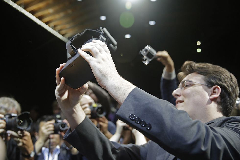 Palmer Luckey holds up an Oculus Rift headset, June 2015