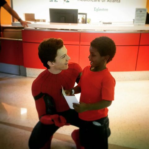 Tom Holland as Spider-Man visits kid's hospital.