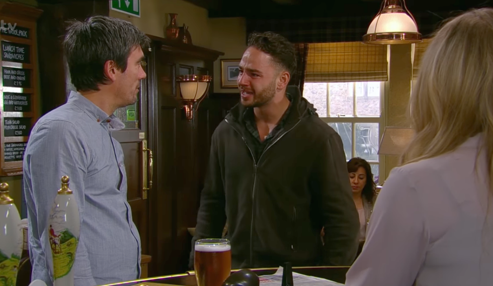 Adam Barton tells Cain Dingle that Holly Barton is dead in Emmerdale