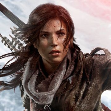 rise of the tomb raider key art, showing lara croft in a thick jacket climbing a snowy mountain