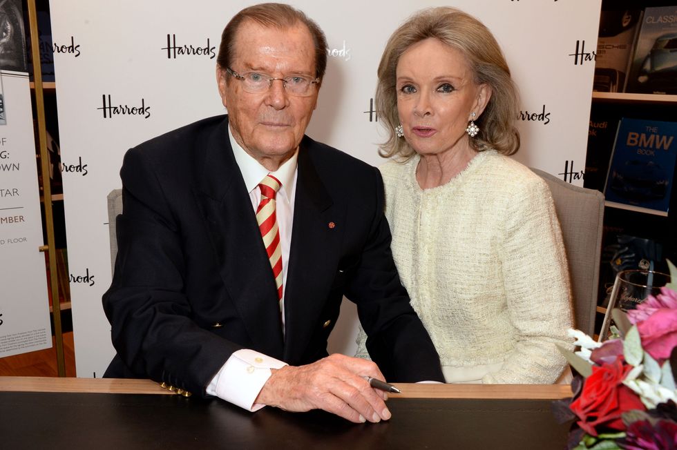 Roger Moore signs copies of his new book 'Last Man Standing: Tales from Tinseltown' alongside wife Kristina Tholstrup at Harrods Bookshop on September 11, 2014 in London, England