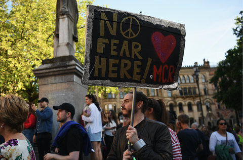 Members of the public gather at a vigil, to honour the victims of Monday evening's terror attack, at Albert Square on May 23, 2017 in Manchester, England.