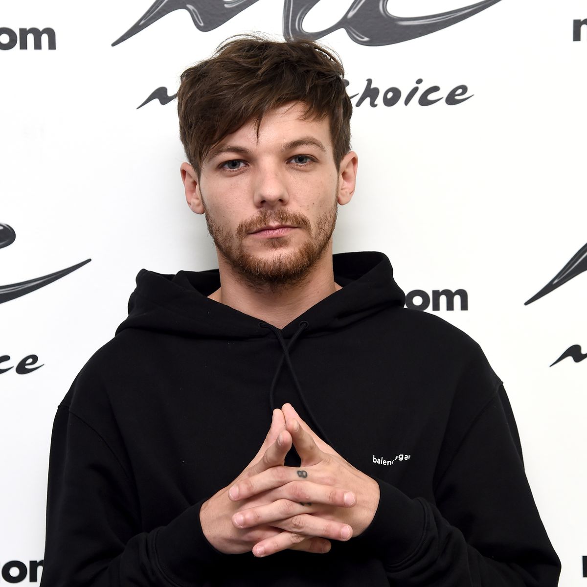 New dad Louis Tomlinson pictured 'drinking under age and