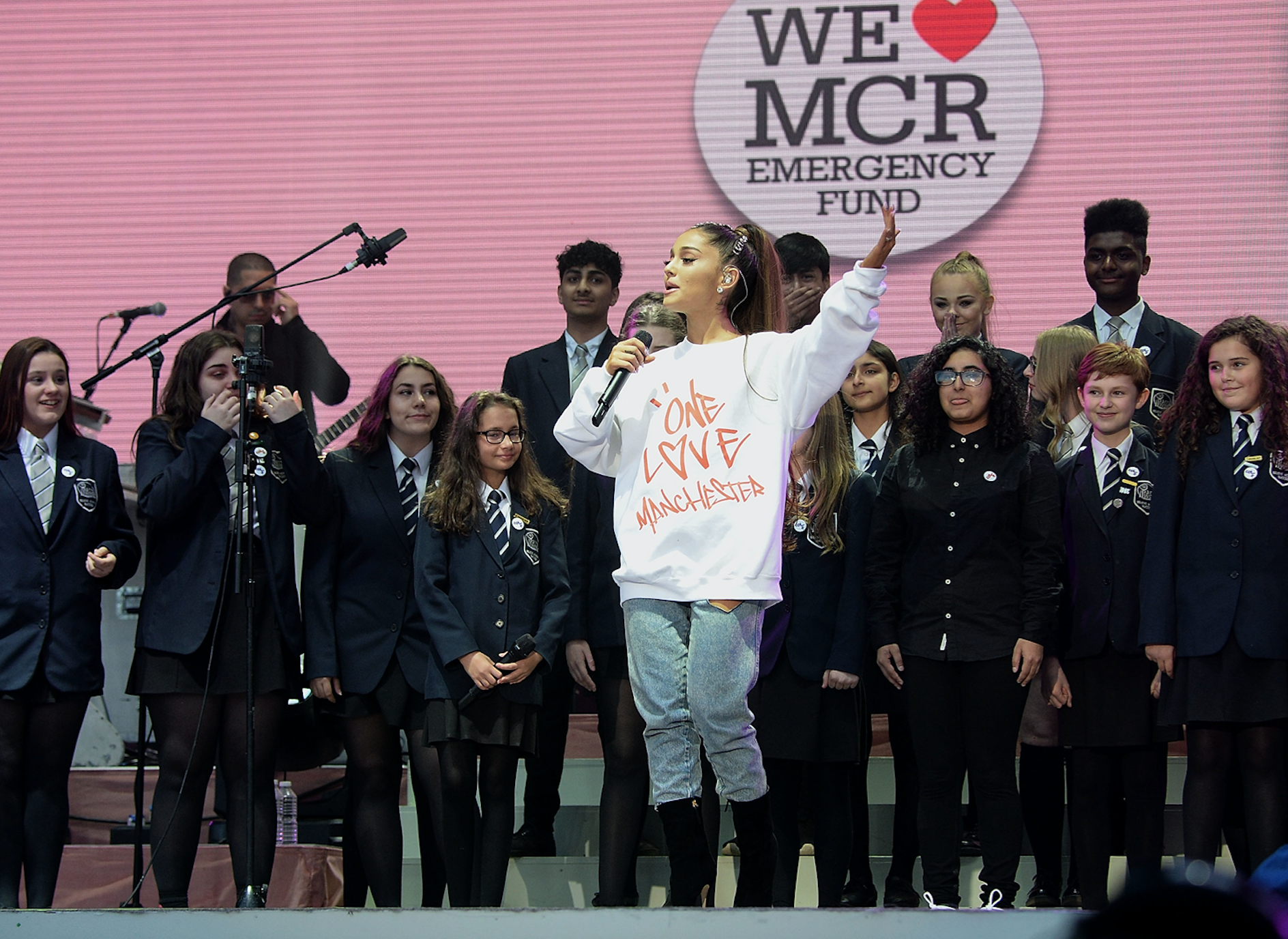 Ariana Grande performs on stage with Parrs Wood High School Choir during the One Love Manchester