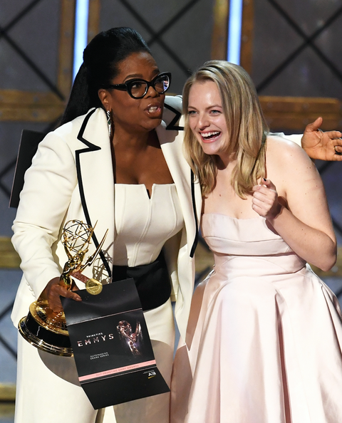 Elisabeth Moss (R) accepts Outstanding Drama Series for 'The Handmaid's Tale' from Oprah Winfrey onstage during the 69th Annual Primetime Emmy Awards