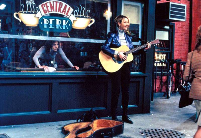 Phoebe with her guitar outside Central Perk, Friends