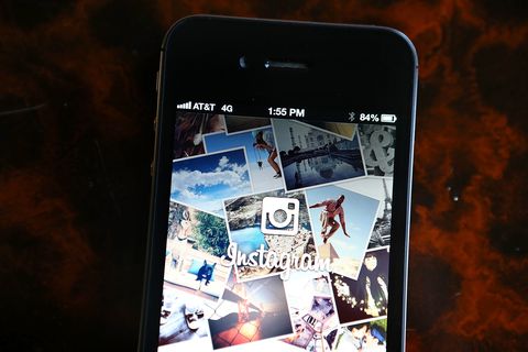 Instagram logo is displayed on an Apple iPhone
