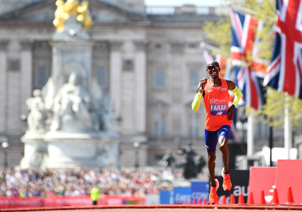 Mo Farah of Great Britain crosses the finish line to take third place during the Virgin Money London Marathon at United Kingdom