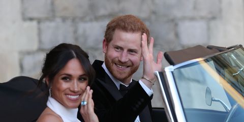 Meghan Markle and Prince Harry wave to the crowds as they head to their wedding reception