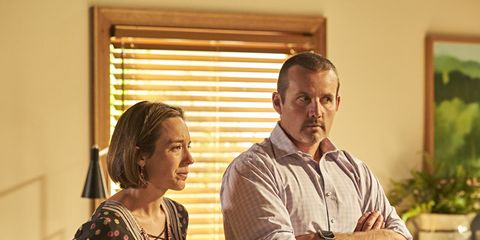 Sindi Watts hands a baby over to Toadie and Sonya Rebecchi in Neighbours