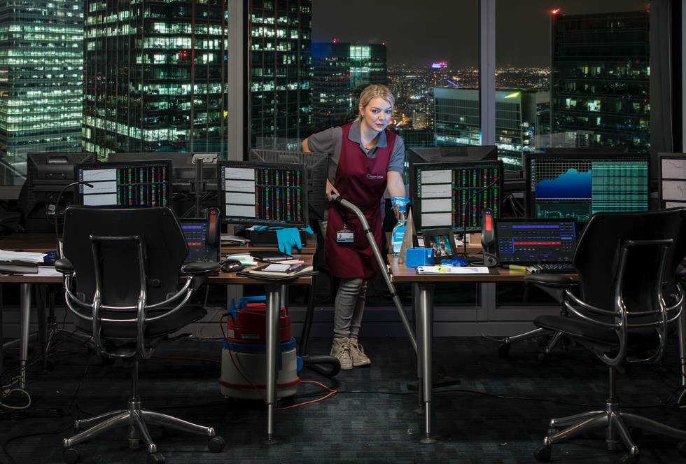 Sheridan Smith vacuums in an apron in a high-rise London office on ITV's Cleaning