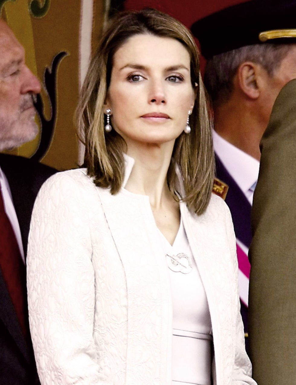Lip, Eye, Hairstyle, Sleeve, Cap, Collar, Formal wear, Interaction, Blazer, Eyelash, 