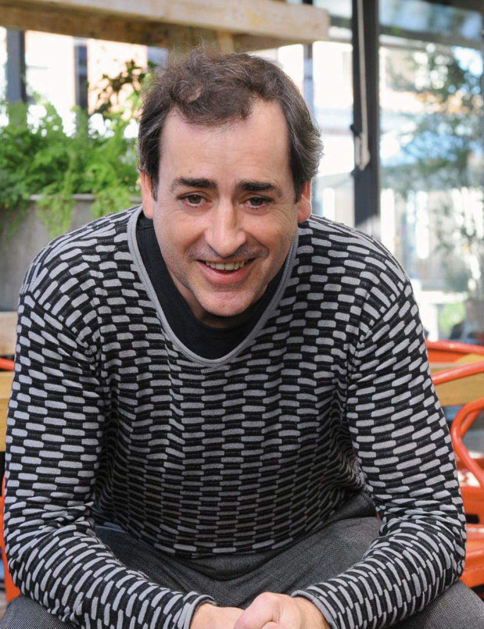 Happy, Facial expression, Sitting, Long-sleeved t-shirt, Sweater, Laugh, Portrait photography, 