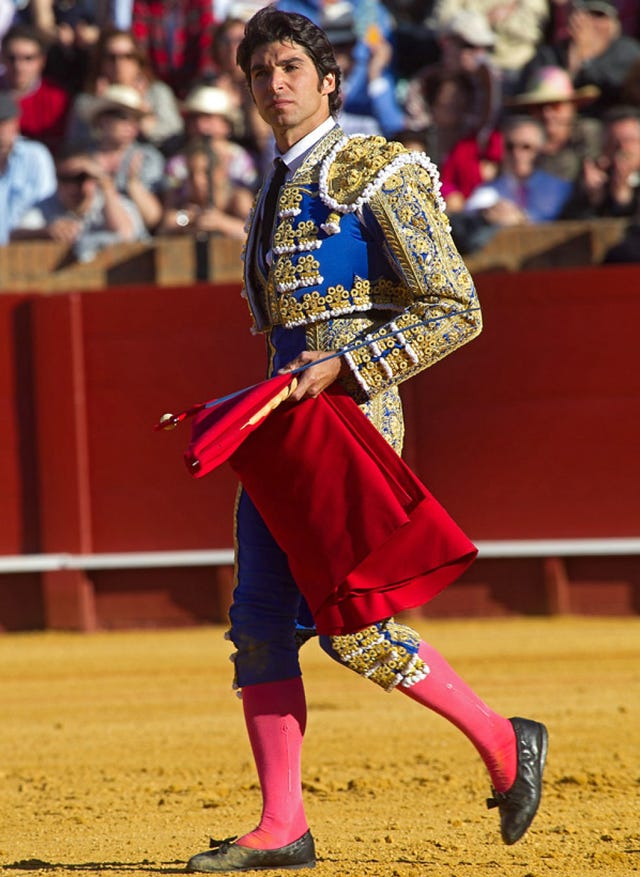 Shoe, Human leg, Matador, Magenta, Tradition, Fashion accessory, Carmine, Performance, Bullring, Public event, 