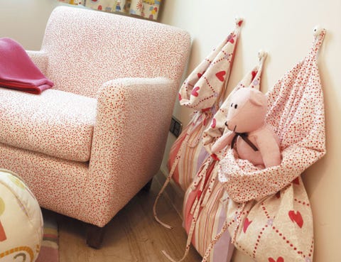 Doll, Toy, Peach, Club chair, Armrest, Living room, Fawn, Couch, Ball, Throw pillow, 